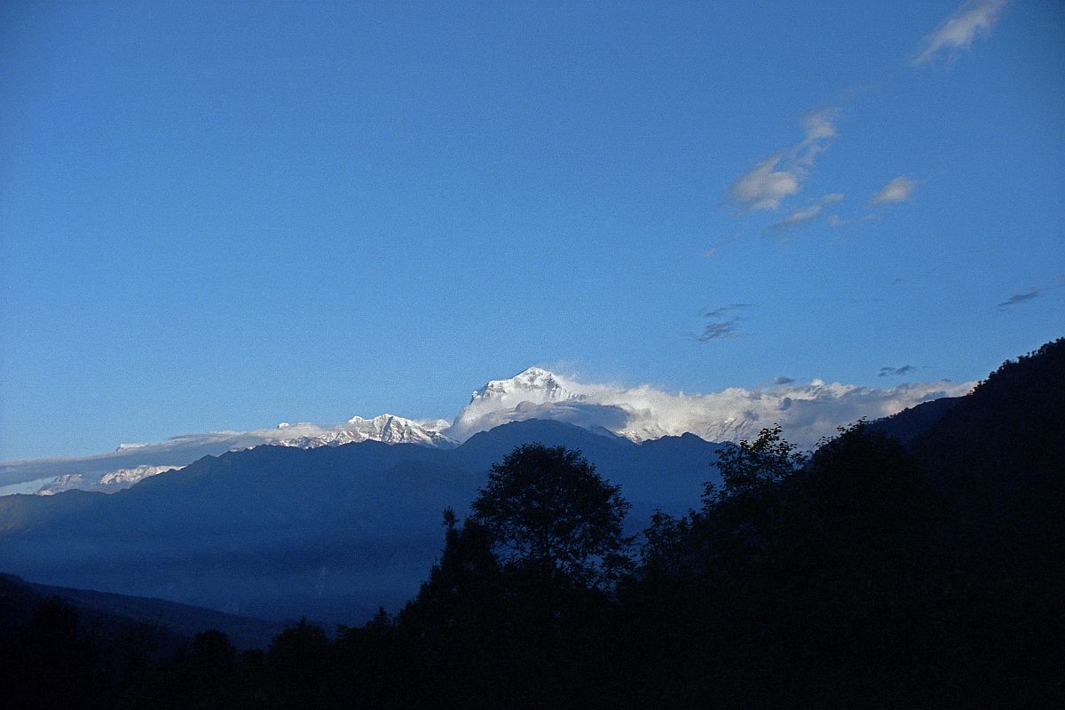 601 Dhaulagiri Sunrise From Chitre Up at 5:45. I had a great view of sunrise on Dhaulagiri from the dining room window at the New Dhaulagiri Hotel in Chitre (2420m). This view is basically the same as that from the famous Poon Hill.